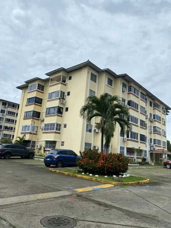 Multi-story cream apartment buildings with balconies and parking at Residencial Parque del Este Panama