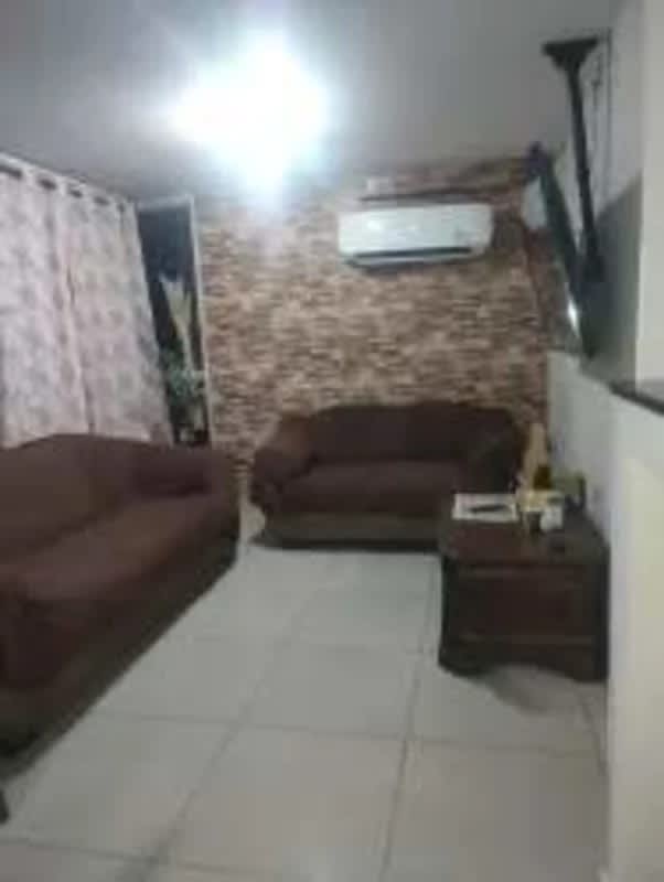 Living dining area with city views, brick accent wall, tiled floors, glass dining set PH Coral Towers Carrasquilla