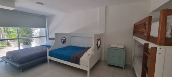 Spacious covered patio terrace with BBQ grill, dining area and seating in Playa Blanca villa Panama