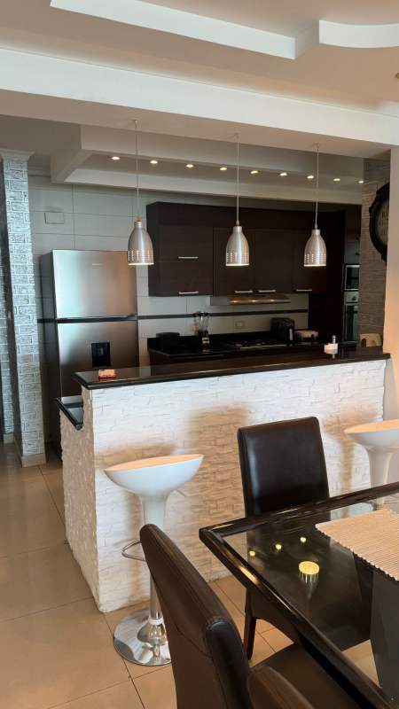 Furnished kitchen with granite countertops, stainless steel appliances in PH Pacific Sea Punta Paitilla Panama