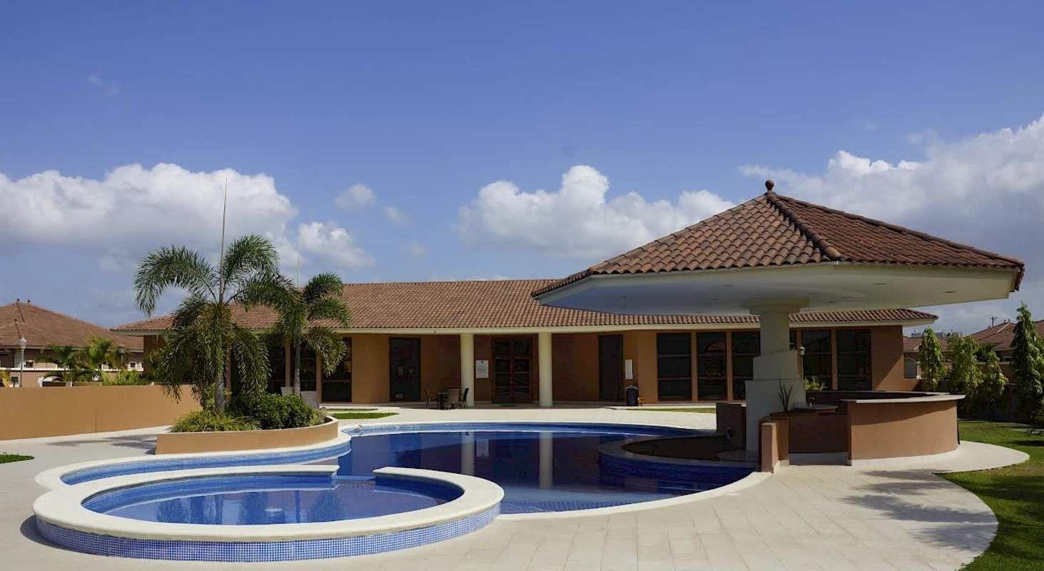 Street-side view with attached garage and circular window Sunset Coast Costa Sur Panama
