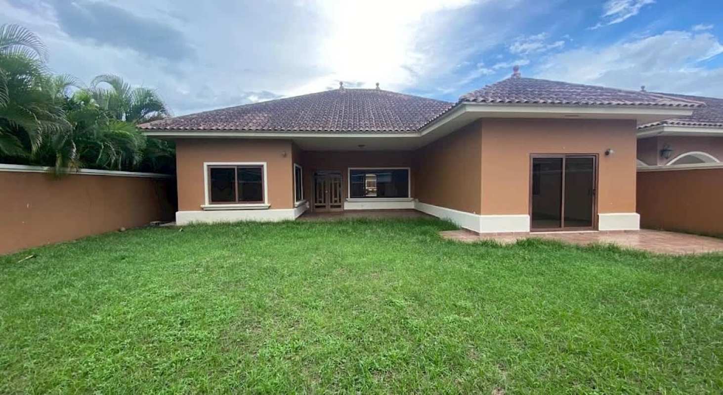 Rear exterior with tiled hip roof, privacy fencing and sliding doors Sunset Coast house Panama