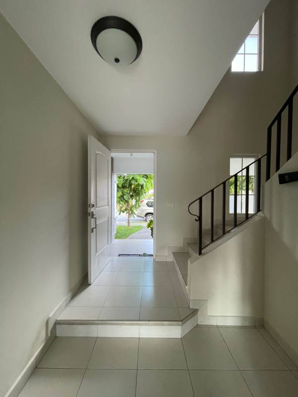 Main entrance foyer with stairs, ample lighting single family house Panama City