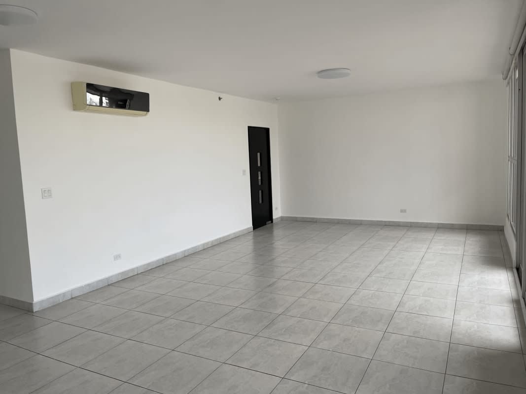 Bright empty living room with tile flooring, large window, modern design in PH Cangrejo Tower Panama City