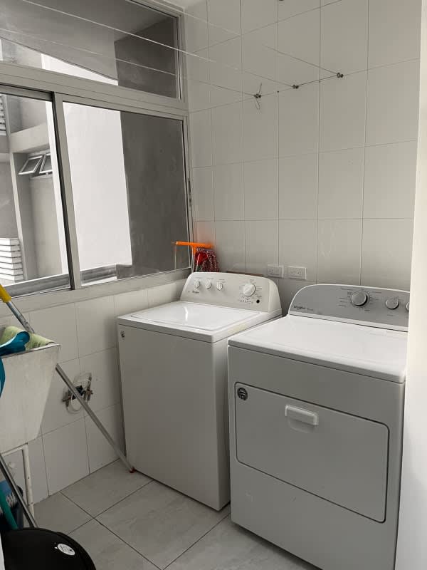Laundry with washer dryer hookups, window, tiled walls El Cangrejo Tower Panama City