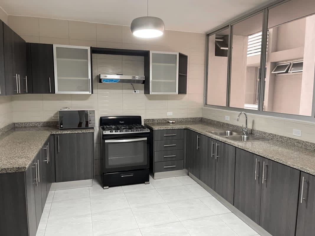 Bedroom with tile floor, large window, city view sunset in El Cangrejo Tower Panama City