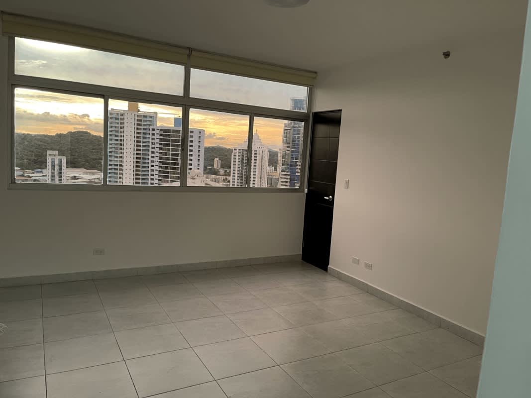 Living room with floor-to-ceiling windows, panoramic skyline view, balcony access in PH El Cangrejo Tower Panama City
