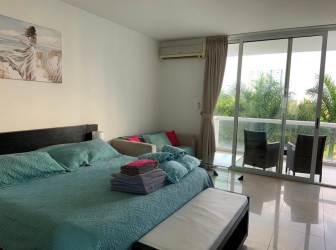 Modern bedroom studio with large sliding doors to balcony at Playa Blanca