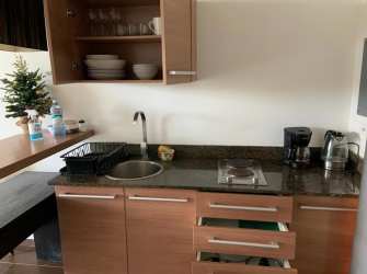Compact modern kitchenette with granite counter Playa Blanca Resort Panama