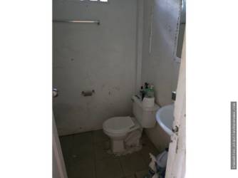 Simple bathroom with toilet, sink, and ceramic tile in Vista Alegre house Arraiján