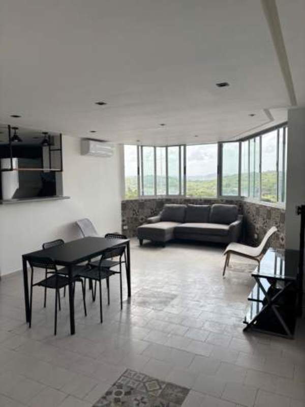 Kitchen with breakfast bar, pendant lights, large window at PH Villa de las Fuentes Panama City