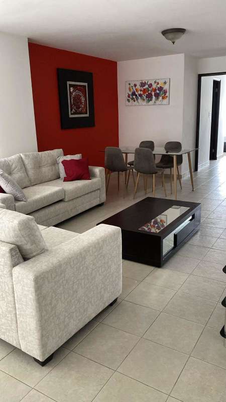 Modern dining area with glass table and accent wall, Punta Paitilla Panama Apartment