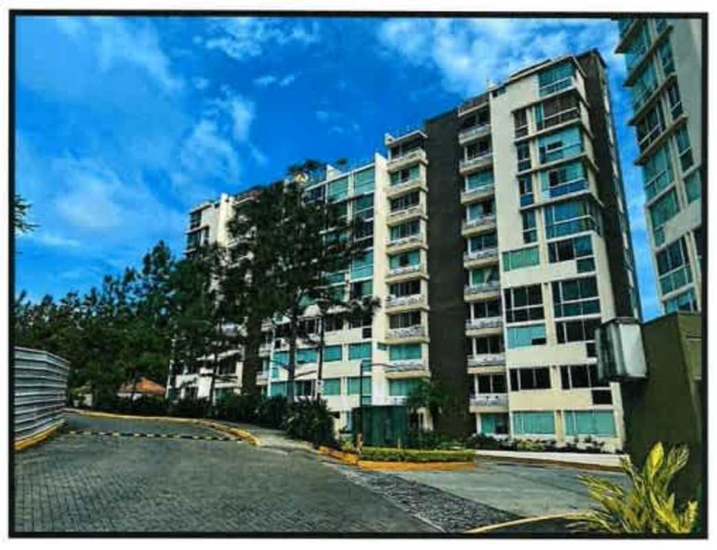 Modern multi-story condominium with balconies and landscaped entrance PH Pine Hills Clayton Panama