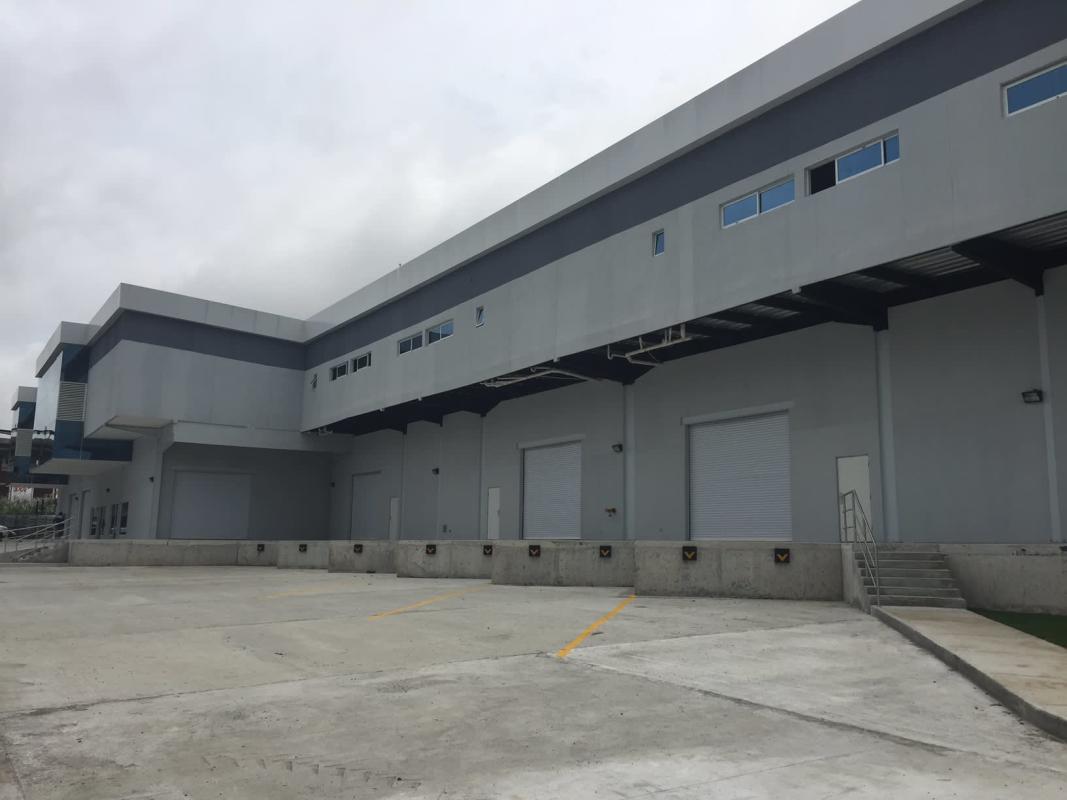 Commercial modern warehouse with glass panels, handicap parking, and stair ramp access in Parque Centenario Panama