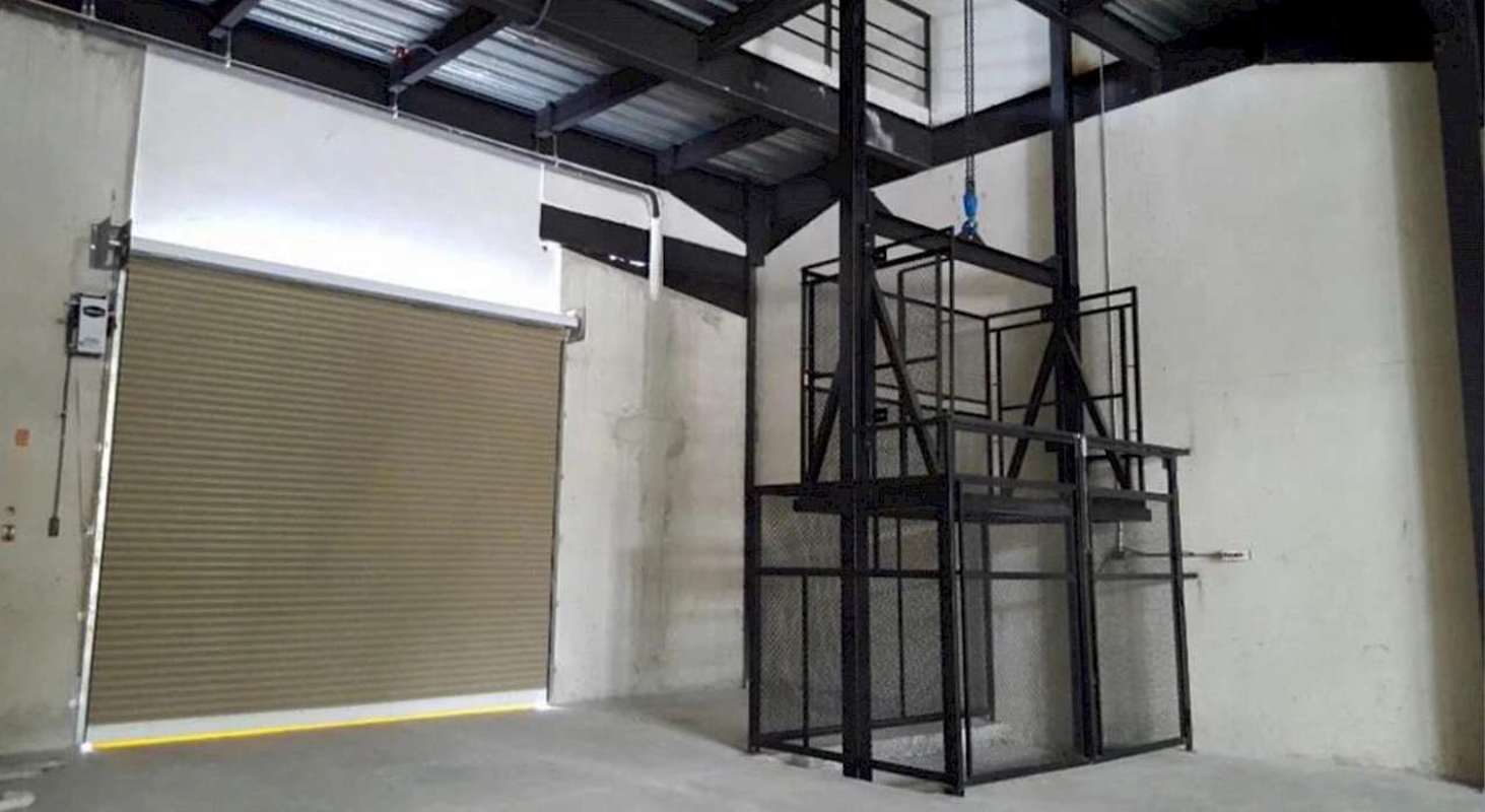 Warehouse interior with cargo lift shaft and large roller shutter Parque Centenario Panama
