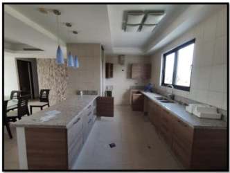Open-plan modern kitchen with granite counters and dining area PH Hoyo 18 Vistamar Golf Beach Resort Panama