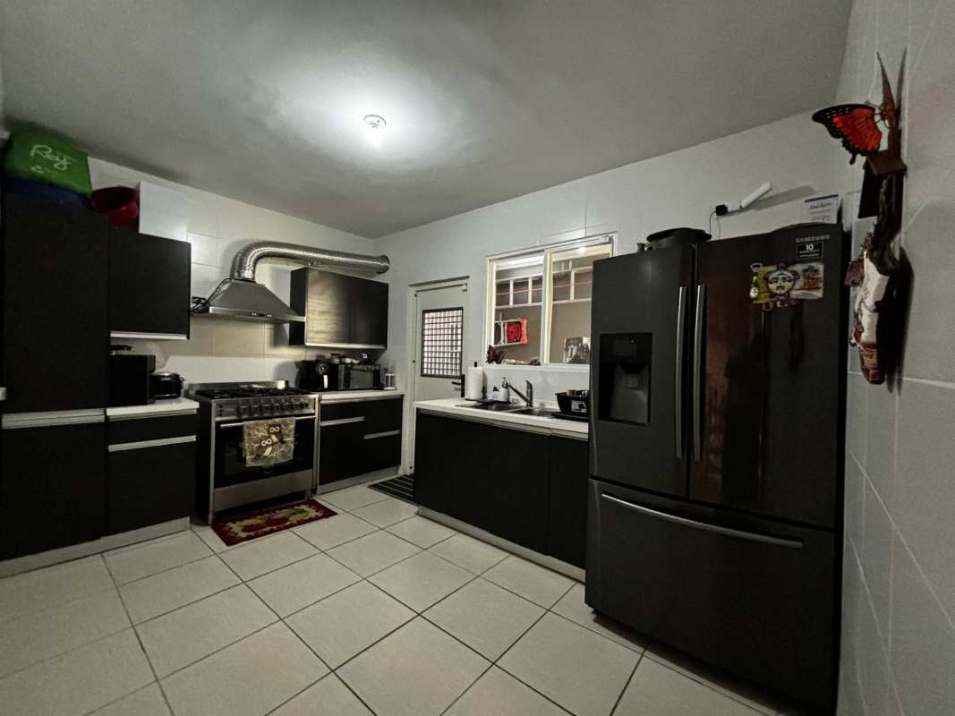Modern kitchen with cabinets, stove and appliances in PH Augusta Brisas del Golf Panama