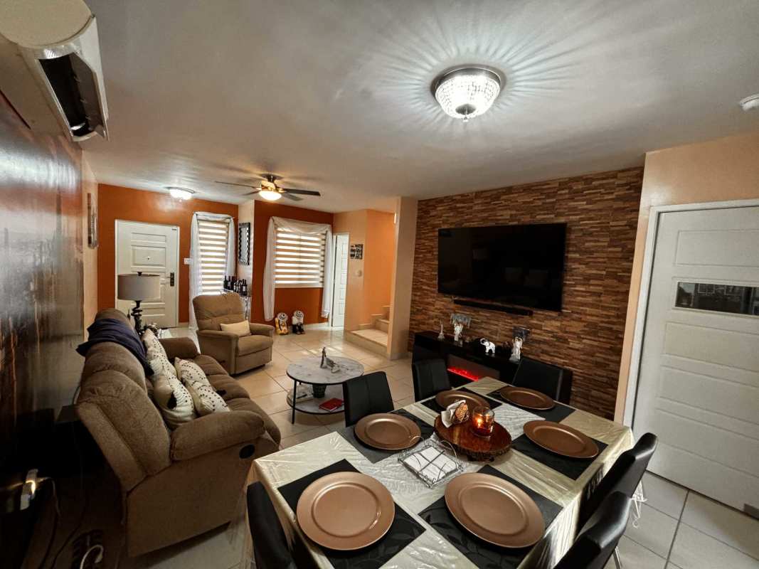 Open living area with TV, accent wall and tile floors PH Augusta Brisas del Golf Panama