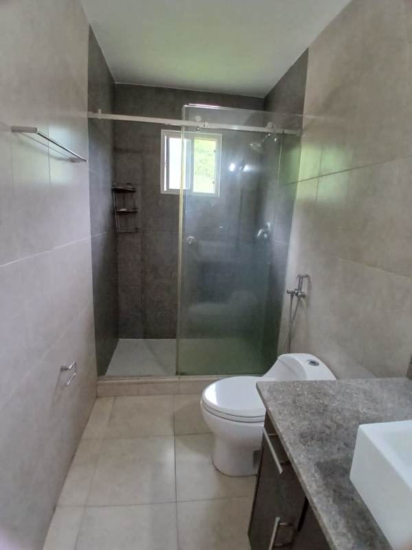 Kitchen with granite countertops, cabinets, large window in Villa Tiber Brisas del Golf Panama