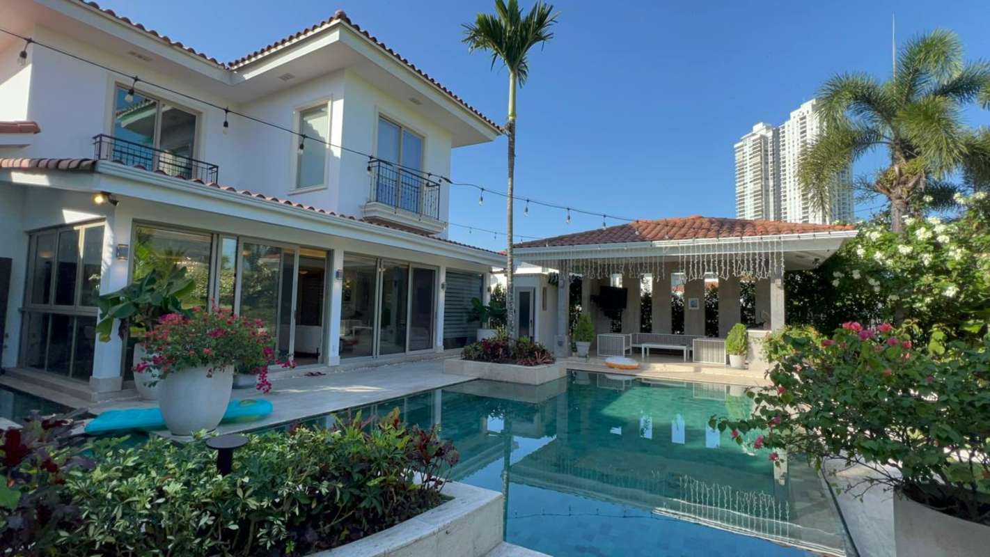 Modern kitchen with island, granite countertops, marble floors in luxury house at Fairway Estates Santa María