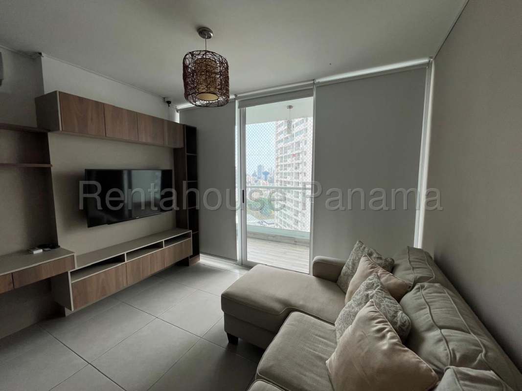 Bright living room with large windows overlooking Panama City in PH Edison Park apartment for rent