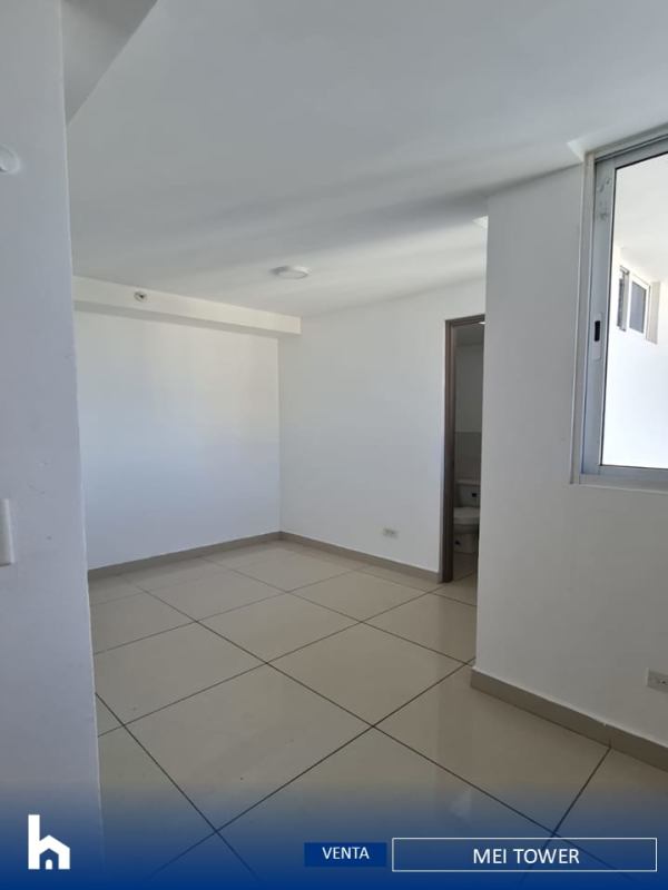 Large master bedroom with ceramic tile flooring and ensuite bathroom in MEI Tower Panama City