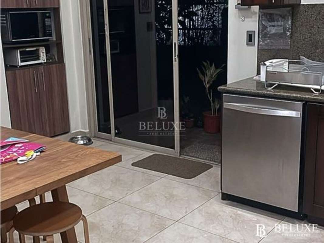 Elegant dining room overlooking lush green backyard at PH Embassy Gardens Clayton Panama