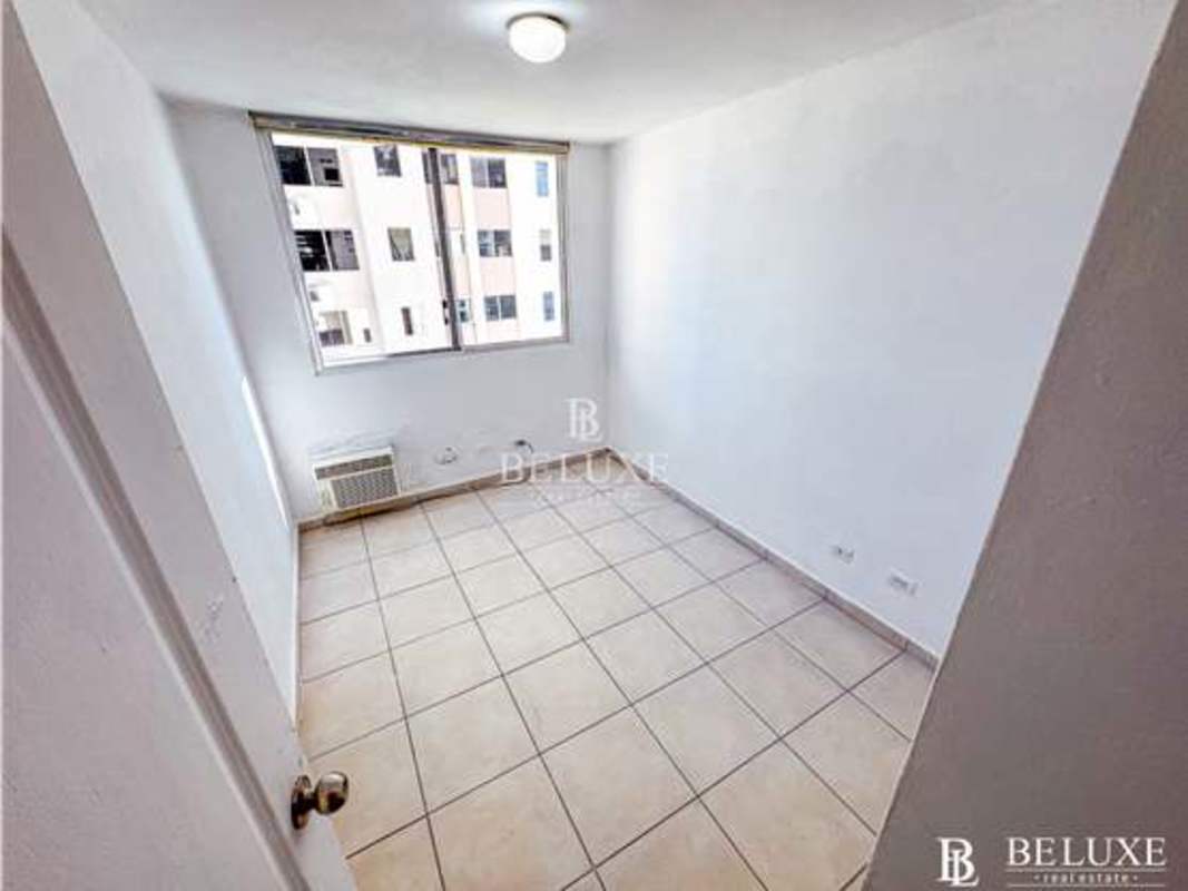 Bedroom with large window and bright view city skyline PH Mar del Sur San Francisco Panama