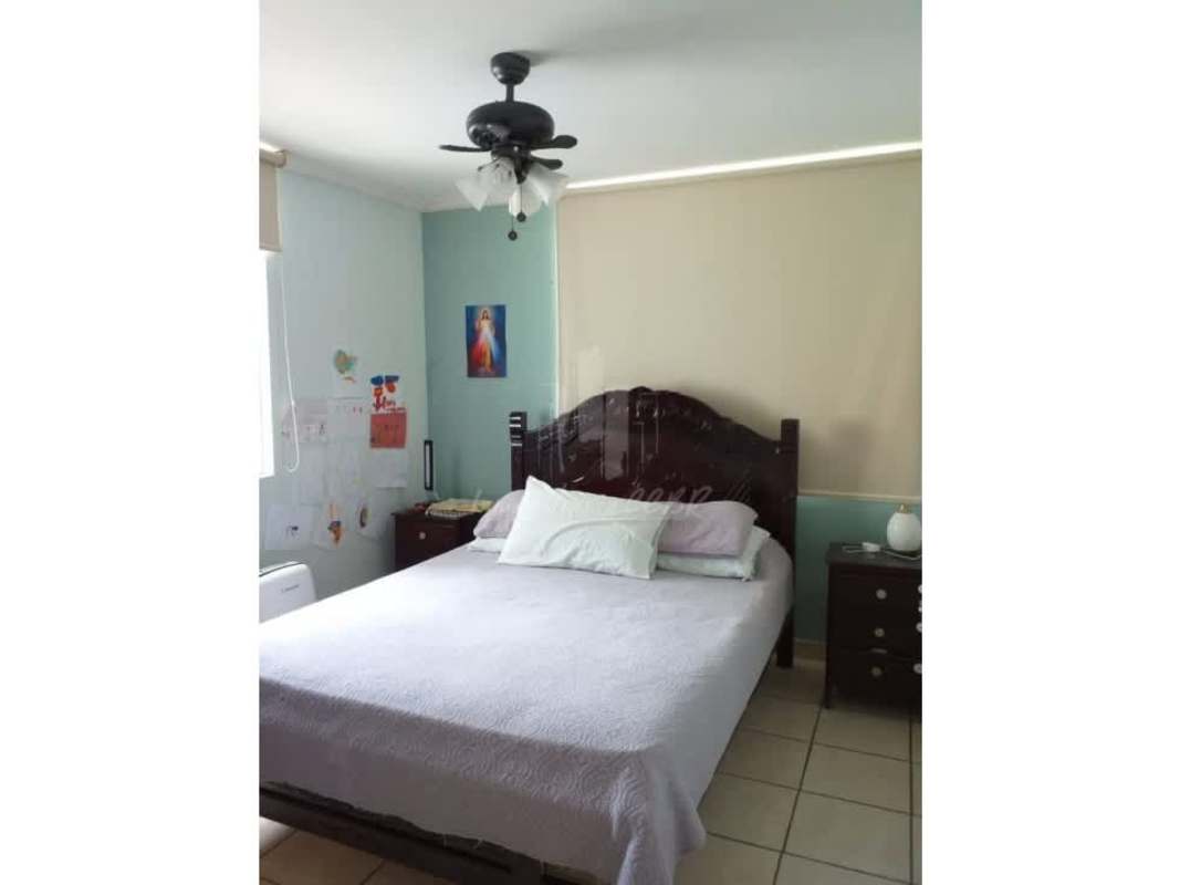 Bright living room with city view window and ceiling fan PH Plaza Valencia in Carrasquilla Panama City