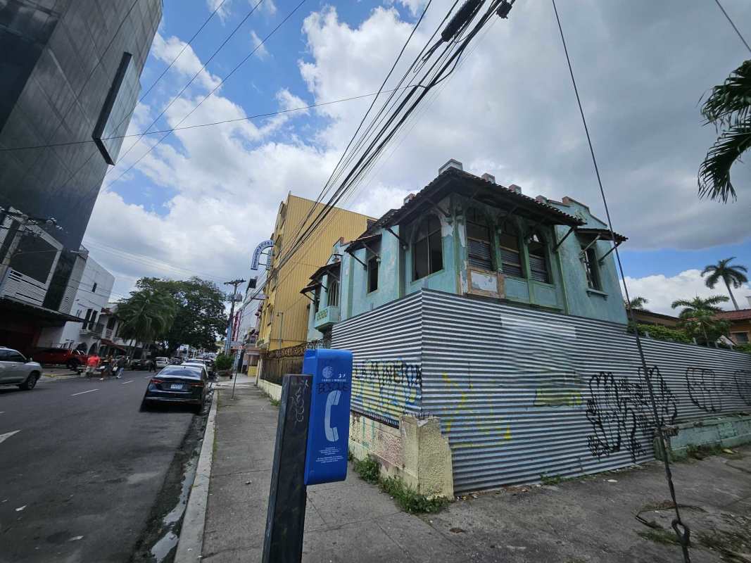 Street view of colonial building with graffiti fencing in Bella Vista central Panama City investment lot