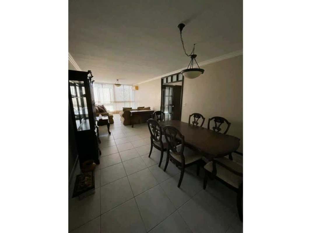 Bright living space with city skyline view through large windows at PH Las Garzas Panama City