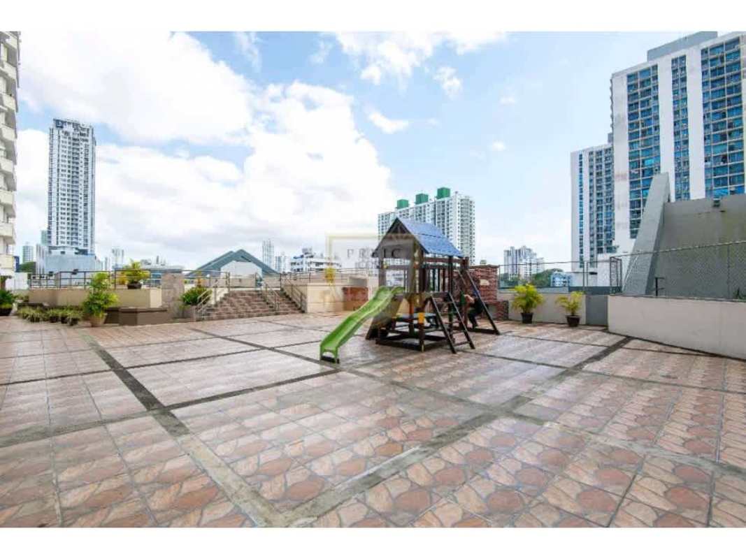 Rooftop terrace with children's playset overlooking Panama skyline PH Brisas de San Fernando