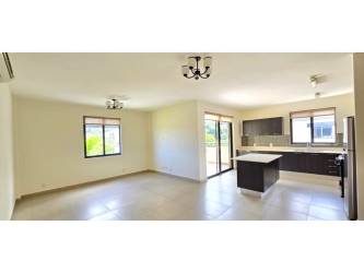 Spacious open-plan living and dining room with large balcony view at River Valley Panama Pacifico