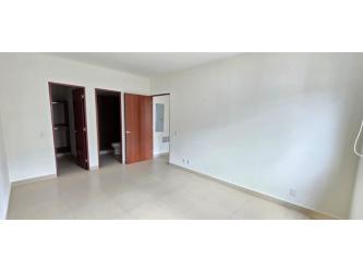 Sunny second bedroom with built-in closet and neutral tones