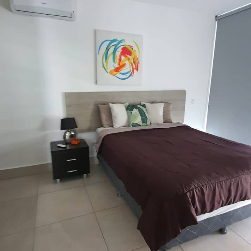 Furnished master bedroom with air conditioning and large windows city view El Cangrejo Panama