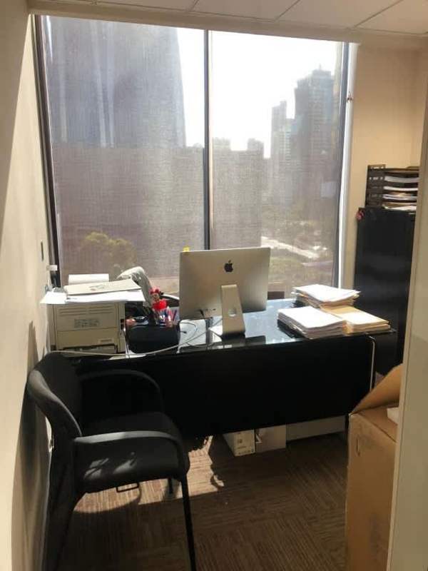 Executive office with large desk, glass wall and city view at PH Obarrio Center Panama