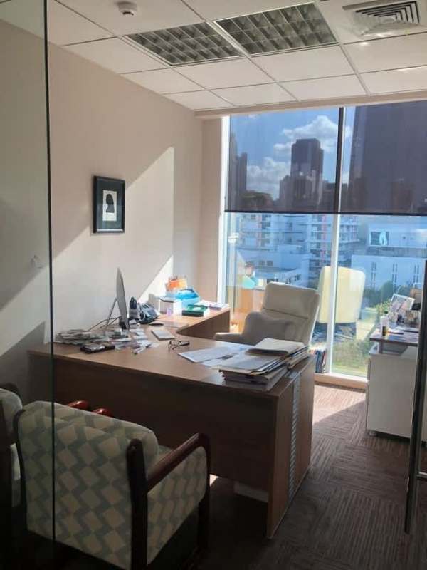 Conference room with city skyline view, wooden table and chairs in Obarrio Center Panama