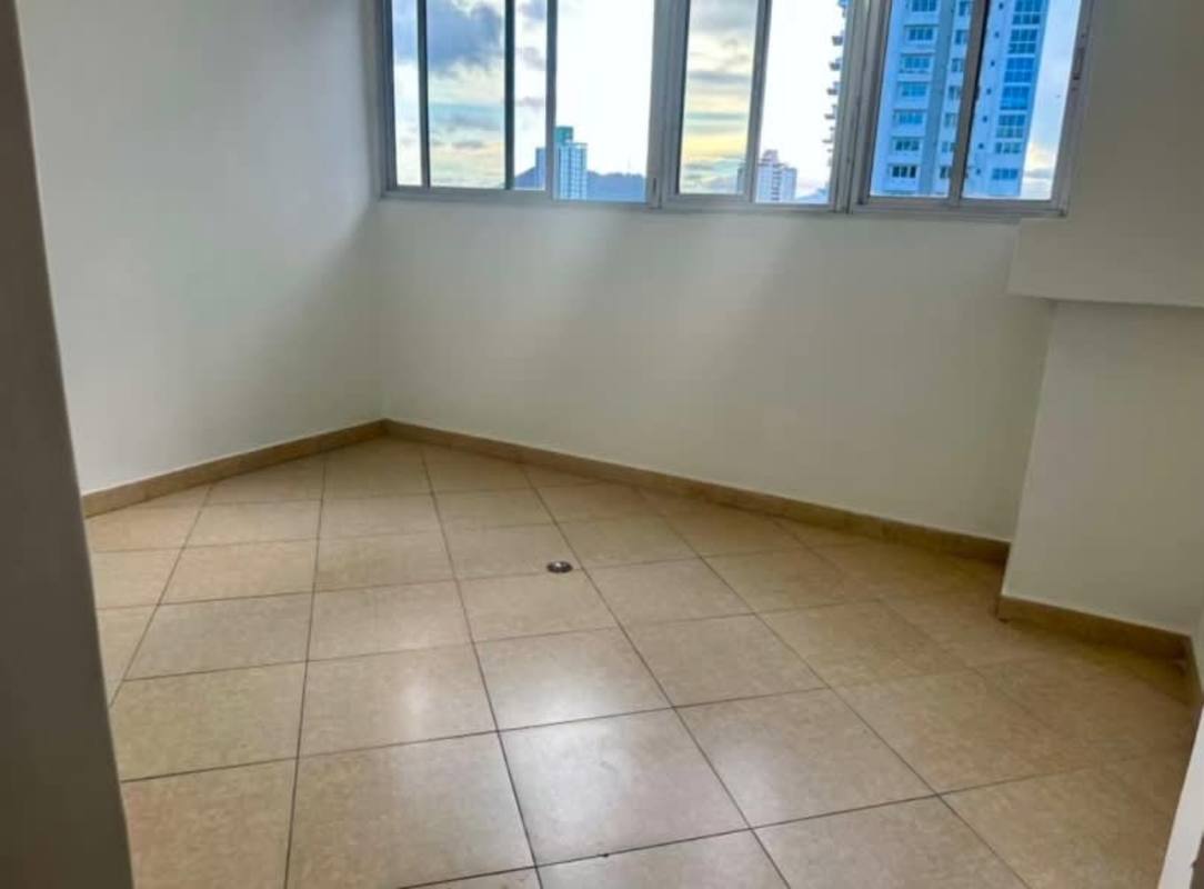 Apartment bedroom with large window and city skyline view at PH Bella Vista Panama City