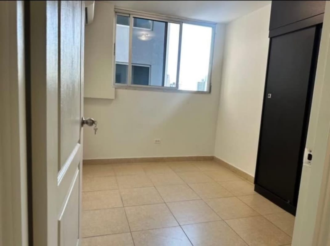 Bedroom with sliding wardrobe, large window and skyline view at PH Bella Vista Panama City