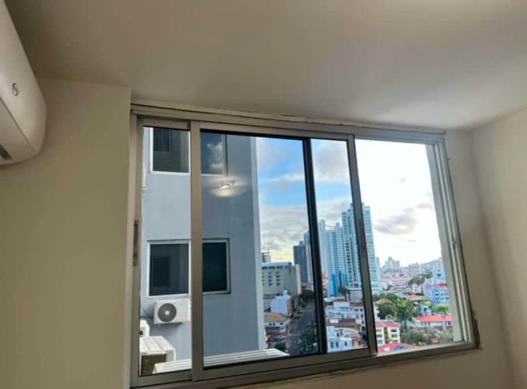 Bedroom with mounted AC, large window and skyline view PH Bella Vista Panama City