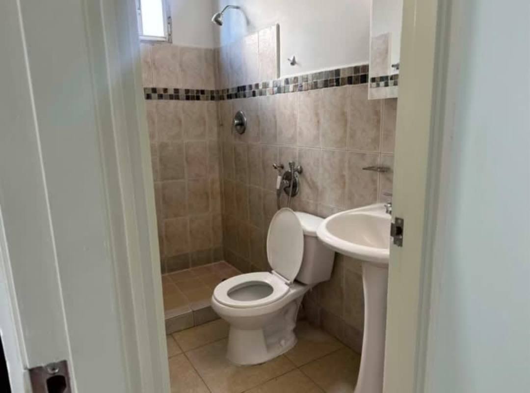 Simple modern bathroom with walk-in shower, pedestal sink PH Bella Vista Panama City