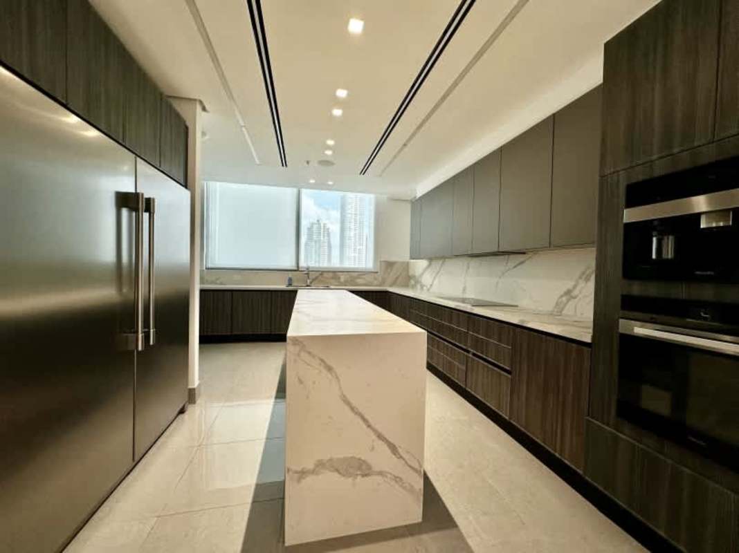 Marble kitchen island, Miele appliances, panoramic window in luxury apartment PH Ocean Front Punta Paitilla Panama