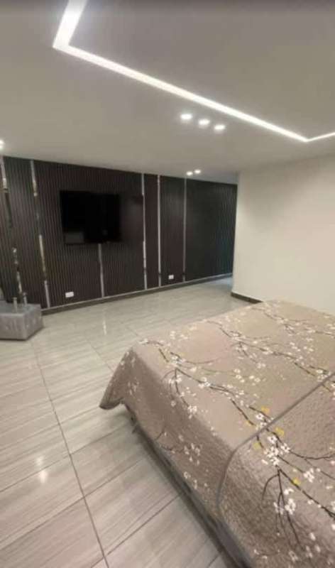 Private swimming pool with tiled deck and privacy wall in furnished rental home Altos de Panamá