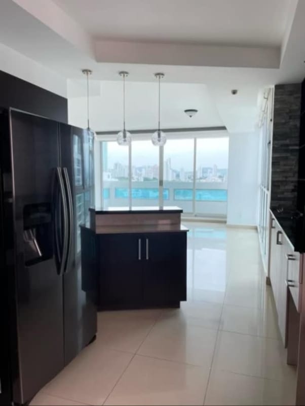 Modern kitchen with granite island and adjacent dining area at PH Coco del Mar Tower Panama