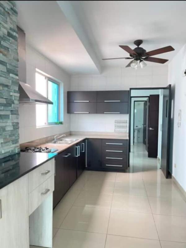 Contemporary kitchen with large island and pendant lights PH Coco del Mar Tower Panama