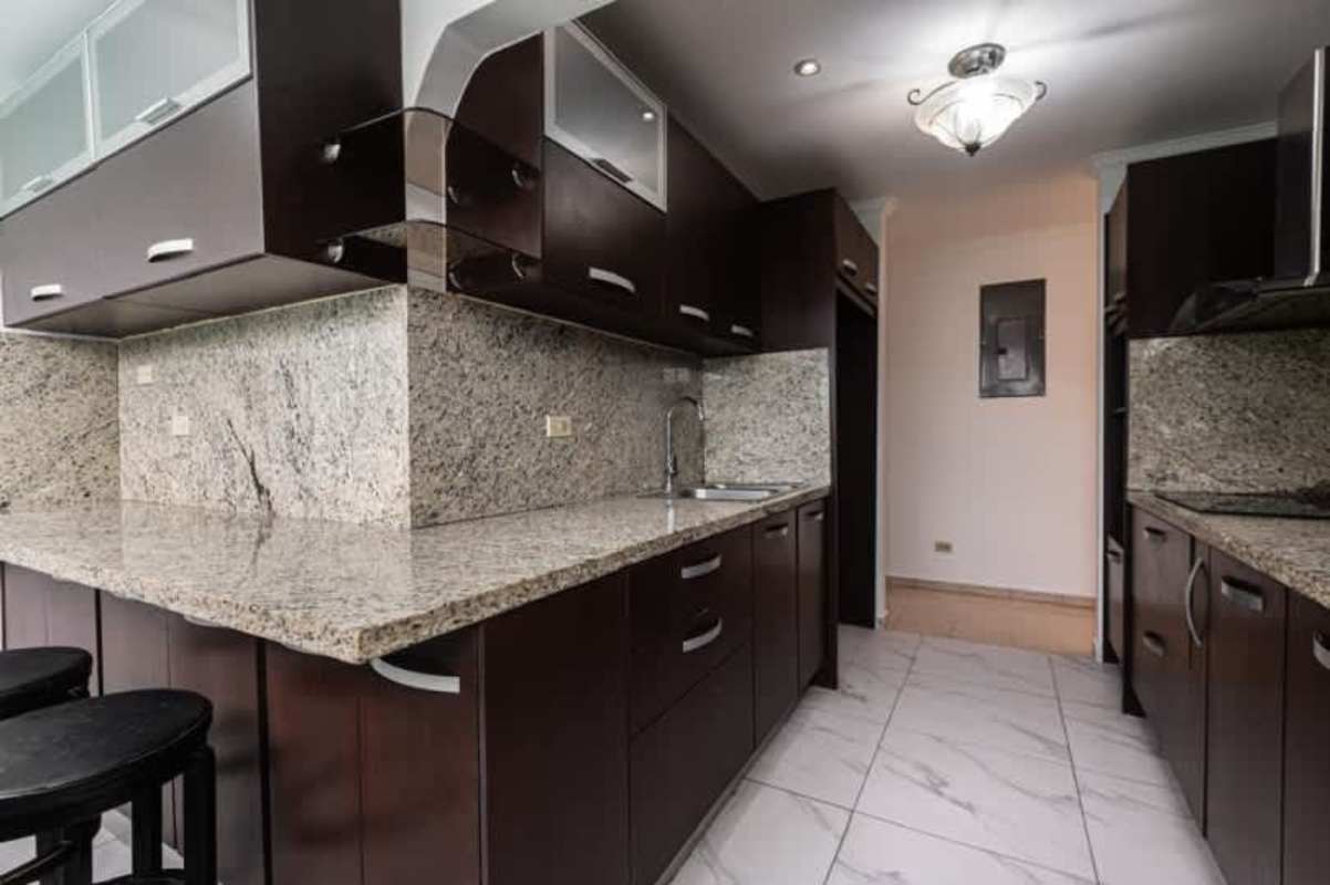 Contemporary kitchen dark wood cabinetry granite countertops house sale Rio Abajo Panama