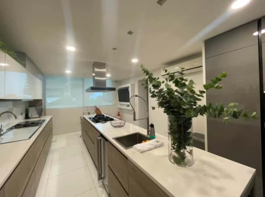 Spacious kitchen with island, integrated appliances bright finishes Ocean Club Tower Panama