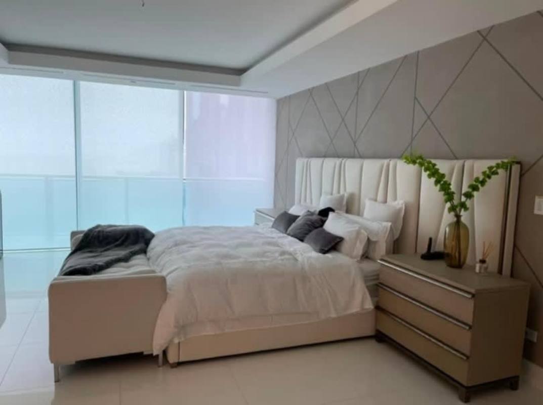 Primary bedroom ocean view, floor-to-ceiling windows, stylish decor in Panama