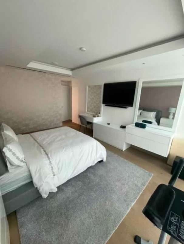 Open plan living dining with mirrored wall, white furniture, skyline views Ocean Club Punta Pacifica