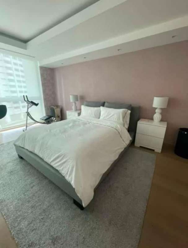 Large bedroom with king bed, modern decor, sweeping window views PH Ocean Club